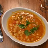 Chana Masala-D · Chickpeas cooked in a traditional onion-tomato sauce. Served with a side of our vegan basmat...