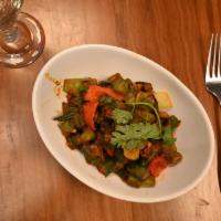 Khatta Bhindi-D · Chopped okra with fresh bell peppers, onions, and dried mango powder. Served with a side of ...