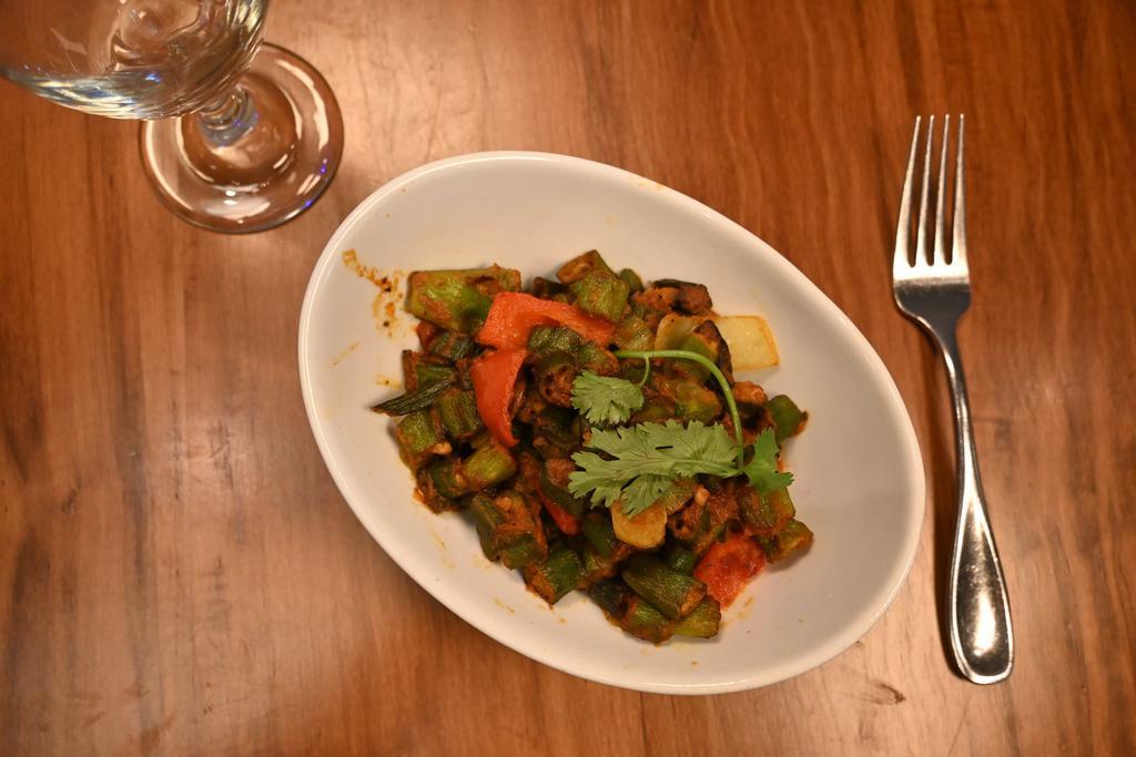Khatta Bhindi-D · Chopped okra with fresh bell peppers, onions, and dried mango powder. Served with a side of our vegan basmati rice. Vegan. Gluten free.