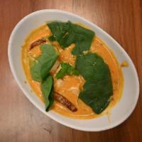Tofu Palak-D · Tofu and fresh spinach cooked in a coconut-flavored sauce. Served with a side of our vegan b...
