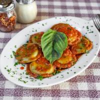Spinach Ravioli · With tomato basil sauce.