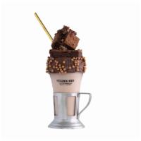 Nutella Crunch Shake · Nutella milkshake with a chocolate frosted rim and salted caramel crunchy pearls, topped wit...