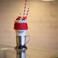 Pavlova Shake · Delicious Pavlova milkshake with a strawberry frosted rim and sprinkles, topped with a crisp...