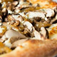 Tuscan Mushroom Pizza · Housemade roasted garlic sauce, mozzarella, cremini, shiitake, and button mushrooms, caramel...