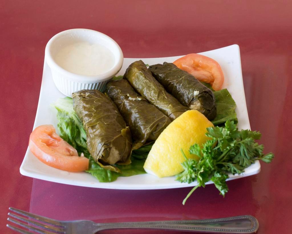 Dolma · Stuffed grape leaves. Stuffed with rice, pine nuts, currants, and chef's spices.