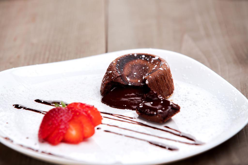 Chocolate Souffle · Moist chocolate cake with heart of creamy rich chocolate ice cream is served optional. Add ice cream for an additional charge.