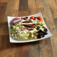 Black and Blue Salad · Crisp iceburg lettuce topped with strips of blackened steak, black olives, red onions, tomat...