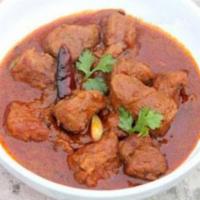 Lamb Rogan Josh · Tender morsels of lamb cooked with ground spices in a tomato sauce. Served with rice.