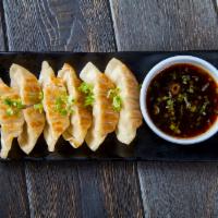 Gyoza Pork · 6 pieces. Pan-fried pork dumplings with house sauce.