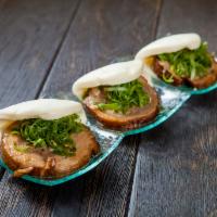 Chashu Pork Bun · 3 pieces. Marinated pork belly with a hint of garlic and green onion wrapped in soft rice bu...
