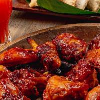 BBQ Wings · Tender pieces of chicken wings marinated in savory BBQ sauce and baked to perfection.