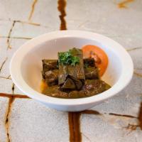Veggie Grape Leaves · Grape leaves stuffed with bell peppers, rice & pomegranate molasses. Served with tahini sauc...