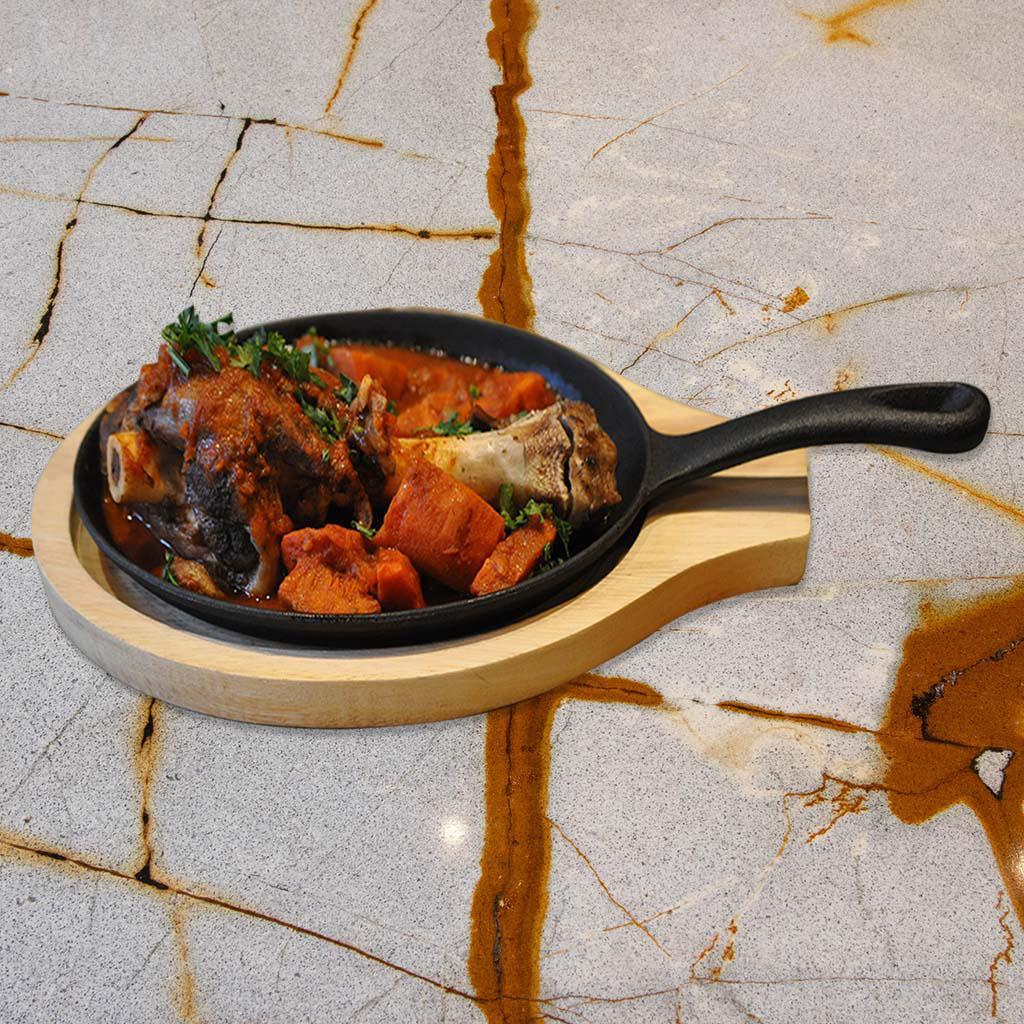 Lamb Shank (GF) · Tender whole lamb shank served with homemade tomato sauce, steamed veggies, and basmati rice on the side. Comes with one Pita Bread.