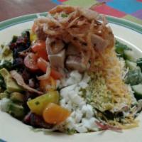 Cleo's Cobb Salad · House salad topped with diced chicken, crispy slab bacon, chopped 
egg, diced avocado, blue ...