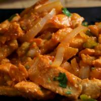 Pechuga Salteada · Chopped sauteed chicken stir-fry with onions and peppers.