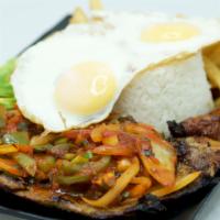 Bistec al Rancho · Grilled sirloin steak with rice, french fries, fried sweet plantains, and avocado.
