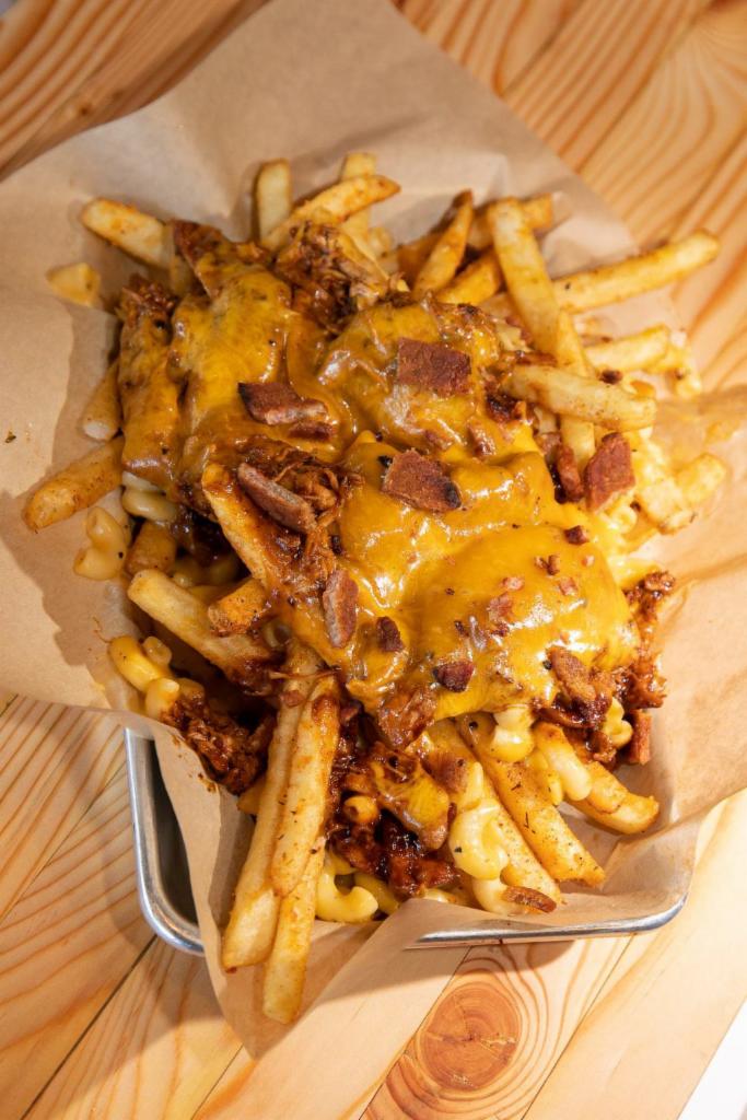 Messy Mac and Cheese · Our signature seasoned fries topped with mac and cheese and your choice of smoked meat, BBQ Sauce, cheese. Sprinkled with pork belly bits.
