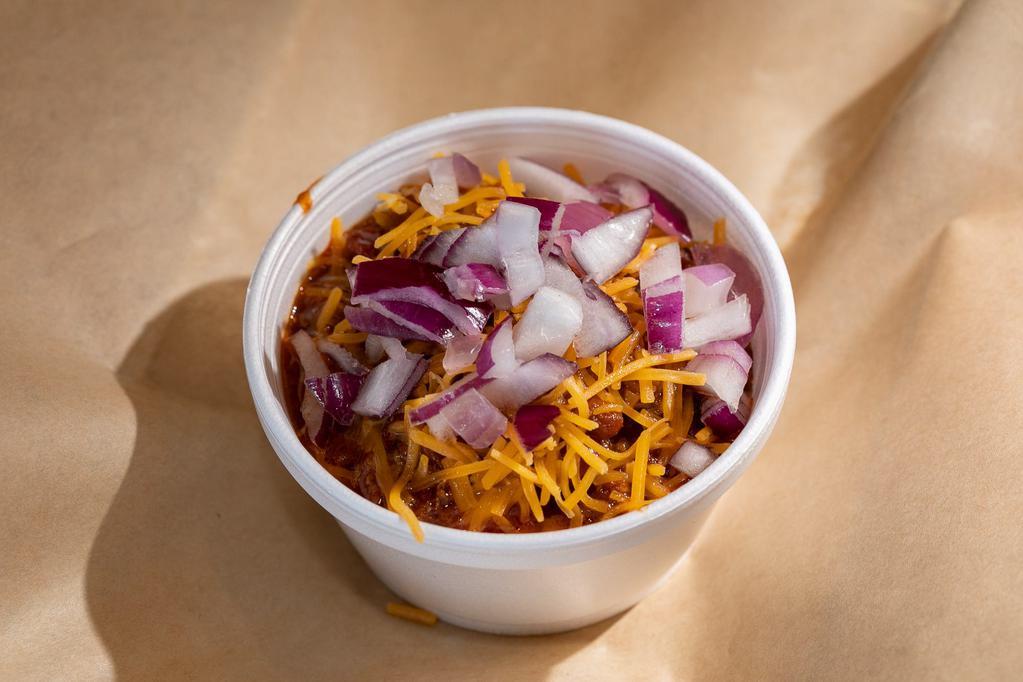 Smokehouse Chili · Our house smoked brisket stewed with red beans, chilies and garlic. Topped with cheese and red onion.