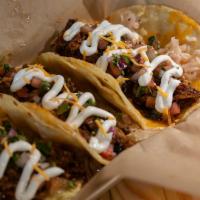 BrushFire Tacos · Corn tortillas filled with your choice of smoked meat, BBQ sauce, cheddar cheese, vinegar sl...