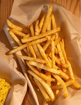 The Fries · Lightly battered fries tossed with our house BBQ seasoning.