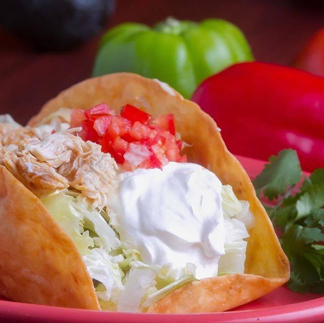 Taco Salad · A large deep fried crispy flour shell filled with your choice of shredded seasoned chicken or ground beef, mixed with lettuce, tomatoes, cheese, and sour cream.
