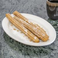 Churros · 3 pieces of fried churros rolled in powdered cinnamon and sugar.