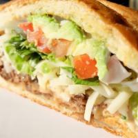 Ground Beef Torta · Served with Mexican blend cheese, lettuce, tomato, beans, avocado, and sour cream.