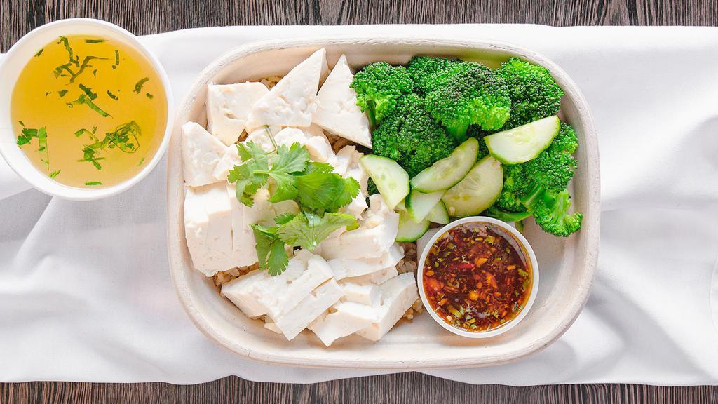 The Vegetarian · Organic tofu, brown rice, and seasonal veggies garnished with cucumber and cilantro. Served with a fresh chili, ginger, garlic, soybean sauce and a side of vegetarian broth.
