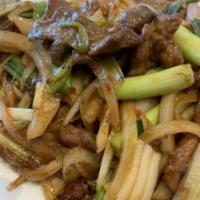 66. Mongolian Beef · Sliced tender beef seared with onions, scallions in spicy sauce. NOTE: There is abundant of ...