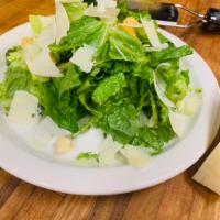 Caesar Salad · Fresh romaine lettuce with homemade croutons and shaved Parmesan cheese.