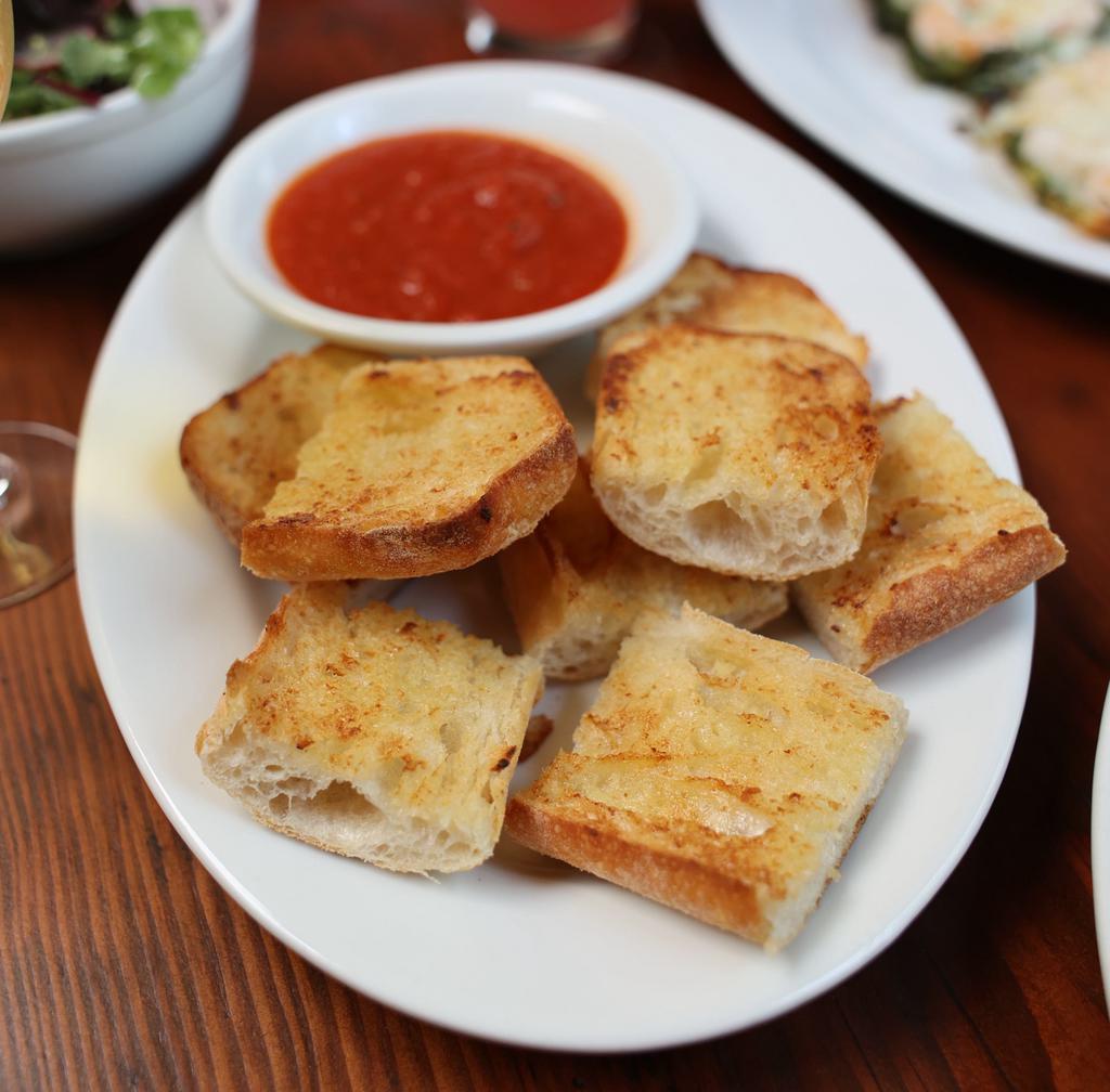 Garlic Bread · A great way to start your meal! Delicious garlic bread served with a side of tomato sauce for dipping