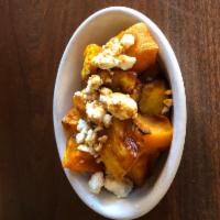 Roasted Butternut Squash · Roasted butternut squash topped with ricotta salata and finished with a drizzle of saba. Glu...