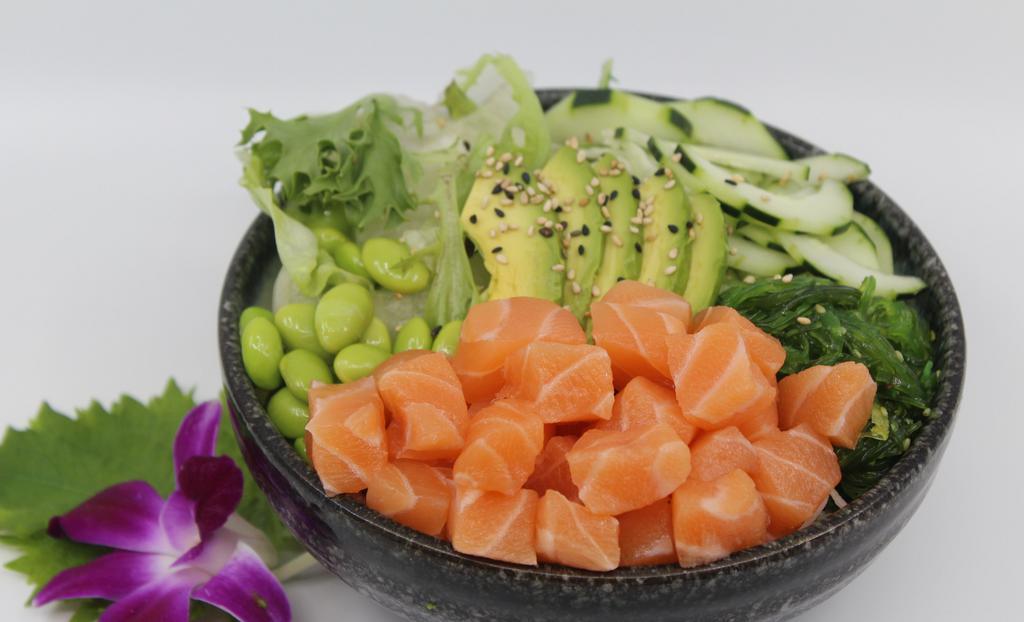 Reg. Salmon Poké Bowl · Choice of protein with rice base, pickled cucumber, avocado, edamame, green leaf lettuce and seaweed salad. Contains raw fish.