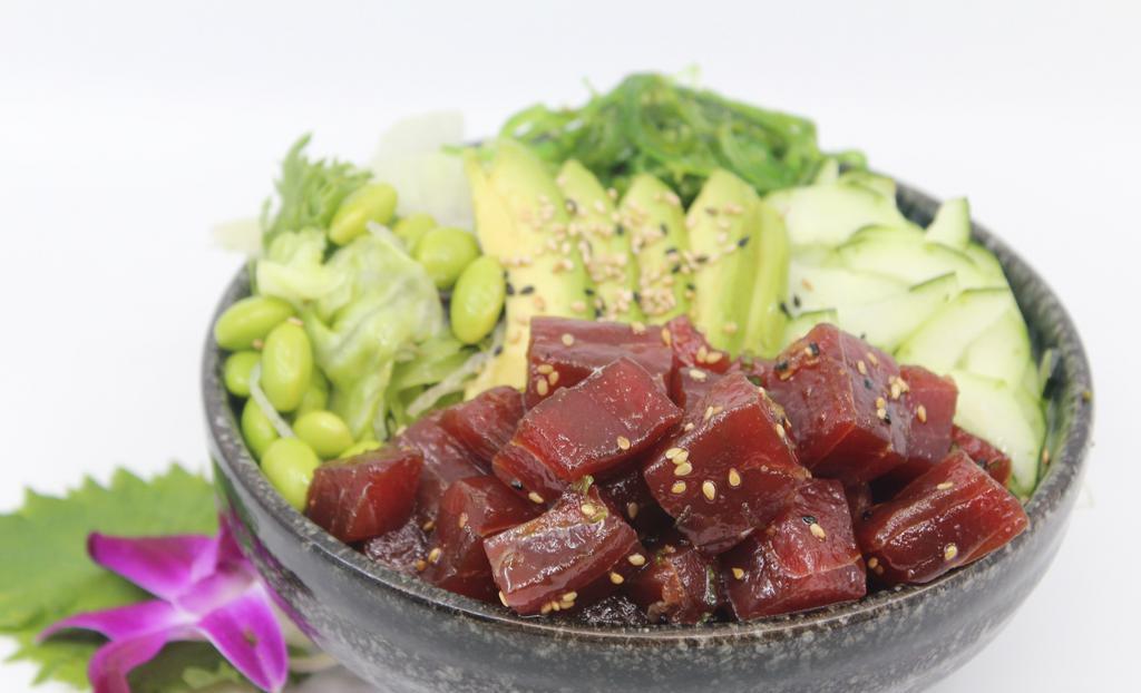 Poké Ahi Tuna Poké Bowl · Choice of protein with rice base, pickled cucumber, avocado, edamame, green leaf lettuce and seaweed salad. Contains raw fish.