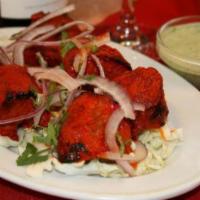 Lamb Boti Kebab · Cubes of lamb marinated in yogurt and fresh ground spices. Served with rice.