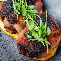 Bacon Wrapped Dates   · Broiled, charred dates wrapped in bacon stuffed with linguica sausage, manchego cheese  
