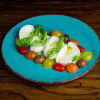 Caprese Insalate · Sliced fresh mozzarella with cherry tomatoes, basil, and extra virgin olive oil.
