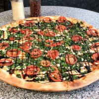 Baby Spinach Caprese Pizza · Crust brushed with olive oil and garlic, mozzarella, baby spinach, and sliced tomatoes drizz...