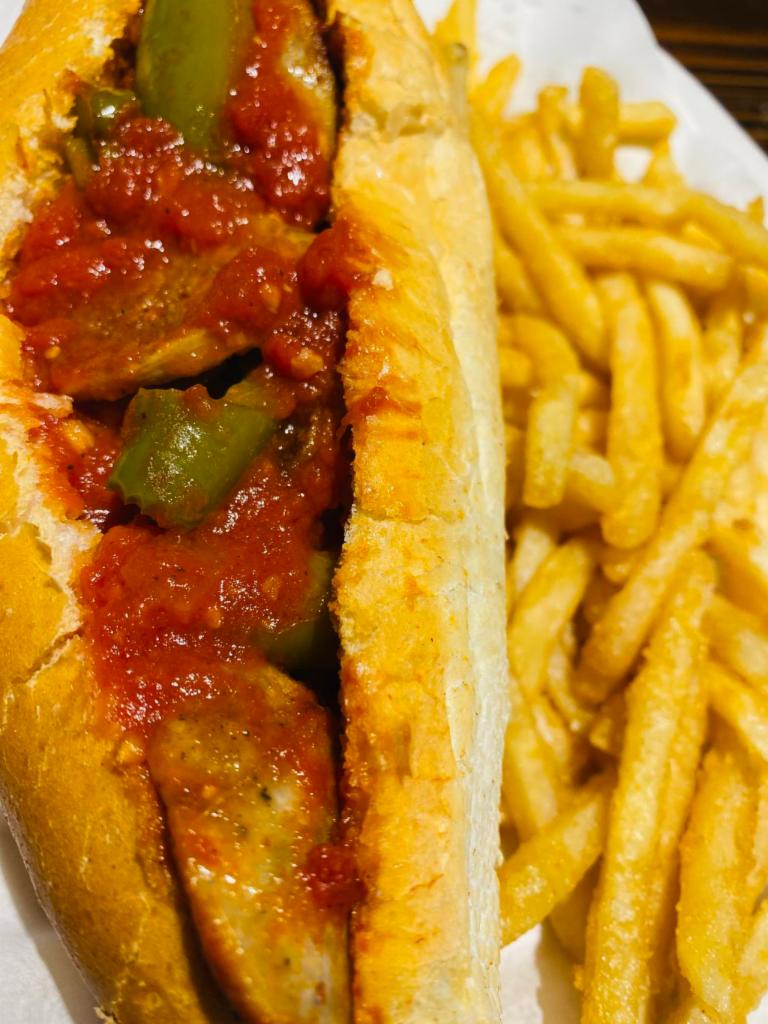 Sausage & Peppers Sandwich · Grilled sausage sauteed with green peppers and our delicious marinara on a fresh Italian roll, served with our house-made chips.