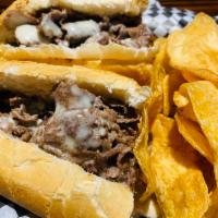 Cheese Steak · Thinly sliced grilled rib-eye steak with melted cheese, served on a soft Italian roll with o...