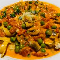 Fettuccine Aurora · House made fettuccine in tomato sauce with peas and mushrooms. Your Choice of Soup or Salad ...
