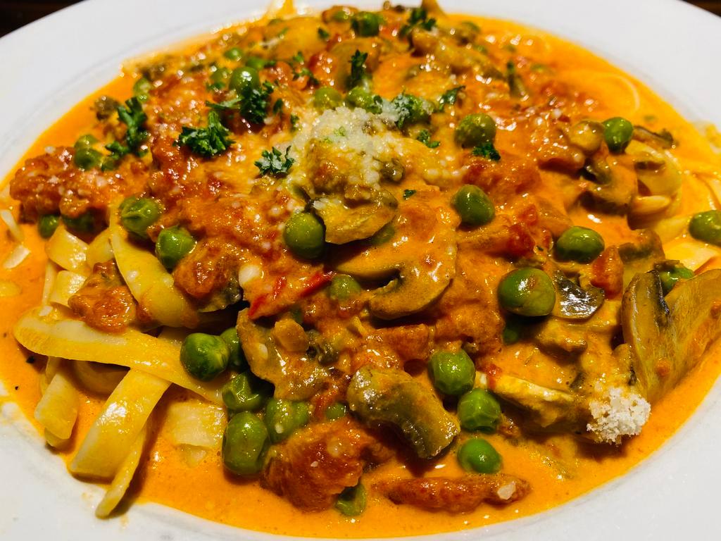 Fettuccine Aurora · House made fettuccine in tomato sauce with peas and mushrooms. Your Choice of Soup or Salad and Garlic Bread