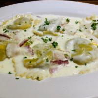 Ravioli Carbonara · Meat ravioli filled in a cream sauce with sauteed bacon. Your Choice of Soup or Salad & Garl...