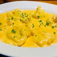 Seafood Ravioli · Mario's hand made crab and shrimp filled ravioli served in a delicious creamy lobster sauce ...
