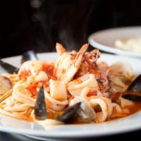 Seafood Fradiavolo · Mussels, clams, shrimp calamari and scallops in a spicy garlic tomato broth served over ling...