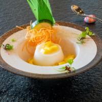 Annin Tofu · Soft, jellied dessert made of apricot kernel milk and agar served with seasonal fruit.