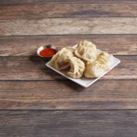 Tibetan Traditions Momos · Eight Tibetan steamed dumplings with lean chopped beef and onions. Served in bamboo with hou...