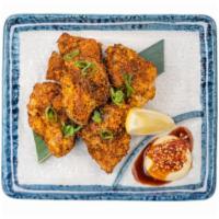 Spicy tori Karaage · marinated fried chicken thigh, tossed in red chile, shichimi togarashi, and nori, served wit...