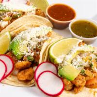 Shrimp Taco · Topped with pico de gallo, avocado, lime wedge, radish, and cotija cheese. Choice of sauce.