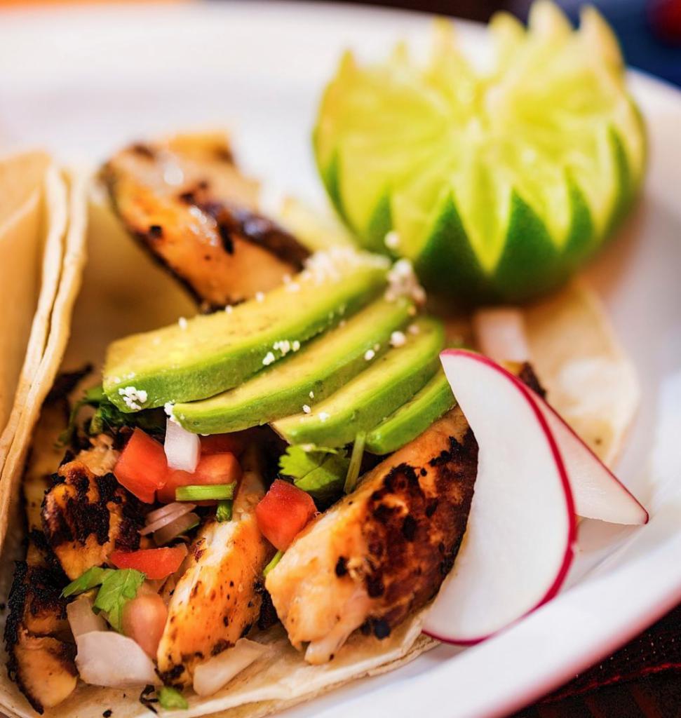 Pescado Taco · Grilled tilapia served on soft corn tortilla. Topped with pico de gallo and chipotle sauce.